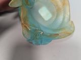 a person that is holding a piece of glass in their hand