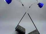 a pair of blue lamps sitting on top of a table
