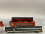 three toy trains that are sitting on a table