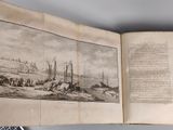 an open book with a picture of boats in the water