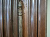 a wooden door with a metal handle in the corner