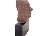an image of a sculpture of a man ' s head on a black stand