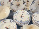 a lot of plates and bowls that are sitting on a table
