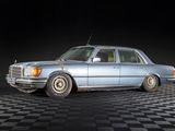 a blue car that is parked on a checkered floor