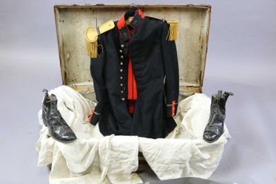 a suit and shoes in a suitcase on a table