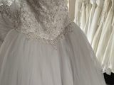 a dress hanging on a rack in a bridal shop
