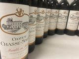 several bottles of wine are lined up on a shelf