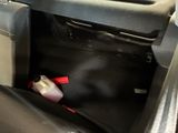 a bottle of liquid sitting in the back of a car