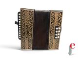 an image of a black and gold accordion sitting on top of a white surface