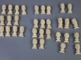 a lot of white marble busts on display on a table