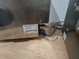 an image of a stainless steel oven on a wooden table