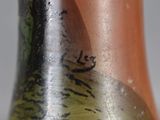 a close up of a vase with a bird on it