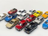 a lot of toy cars that are on a white surface