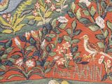 an image of a rug with birds and flowers on a red background