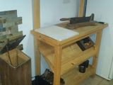 a wooden workbench in the corner of a kitchen