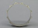 a close up of a silver ring on a gray surface