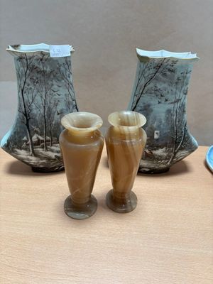 three vases sitting on a table next to each other