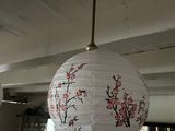 a paper lantern hanging from the ceiling in a restaurant