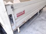 a white dump truck with a red sign on the side