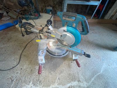 someone is using a circular saw to cut a piece of wood