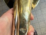 a person holding a brass door handle in their hand