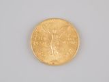 an image of a close up of a gold coin on a white surface