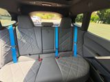the back seats of a car with a blue seat belt
