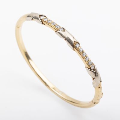 a yellow gold and white gold ring with diamonds