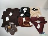 many different types of clothes and shoes on the table