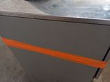 a metal box with a cord on top of it