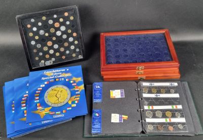 several different types of coins are displayed in a display case