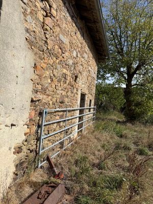 a stone building with a metal fence in front of it