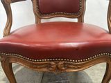 an image of a red leather chair on a stone floor