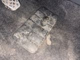 a dirty floor in a car with a dirty floor mat