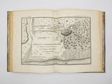 an open book with a map of a town on it