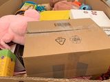 a cardboard box full of stuffed animals in a store