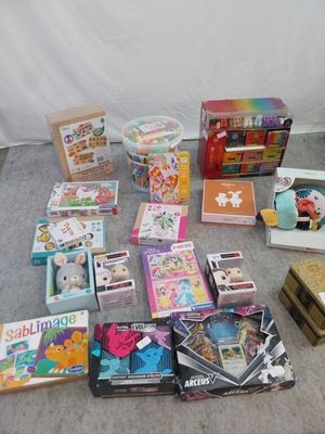 a lot of children ' s toys and books on the floor