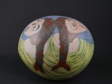 a vase with a painting on it on a black background