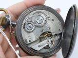 a close up of a pocket watch being held in someone ' s hand