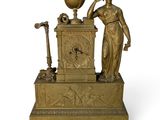 a statue of a woman with a globe on a stand