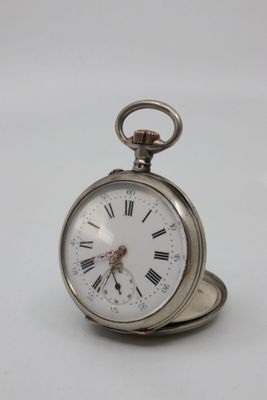 a silver pocket watch with roman numerals on it