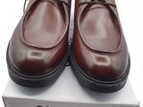men ' s brown leather shoes with laces on top of a box