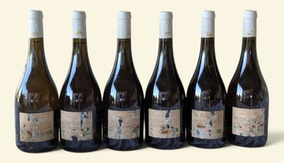 six bottles of wine are lined up in a row on a white surface
