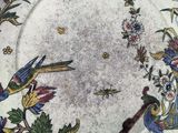an image of a plate with a bird and flowers on it
