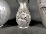 three vases that are sitting next to each other on a table