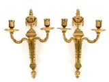 pair of antique brass wall sconces on a white background