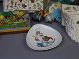 a plate with a cartoon character on it next to other items