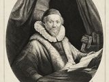 an old black and white photo of a man reading a book