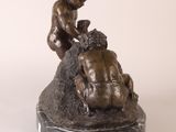 bronze statue of a boy and a dog on a marble base