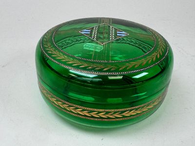 a green glass box with a design on it